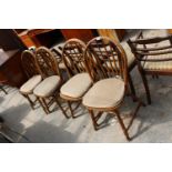 A SET OF FOUR BEECH FRAMED WINDSOR STYLE SPINDLE BACK DINING CHAIRS