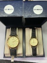 A PAIR OF HIS AND HERS SEKONDA WRIST WATCHES IN PRESENTATION BOXES