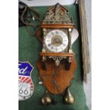 A VINTAGE WOODEN CASED WALL CLOCK, WITH BRASS DECORATION AND PENDULUM, HEIGHT 65CM