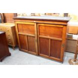 A VICTORIAN MAHOGANY STORAGE CABINET WITH TWO SLIDING DOORS HAVING SUNKEN BRASS HANDLES, 68" WIDE