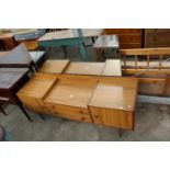 A RETRO TEAK LOW DRESSING TABLE ENCLOSING TWO DRAWERS AND TWO CUPBOARDS, 60" WIDE