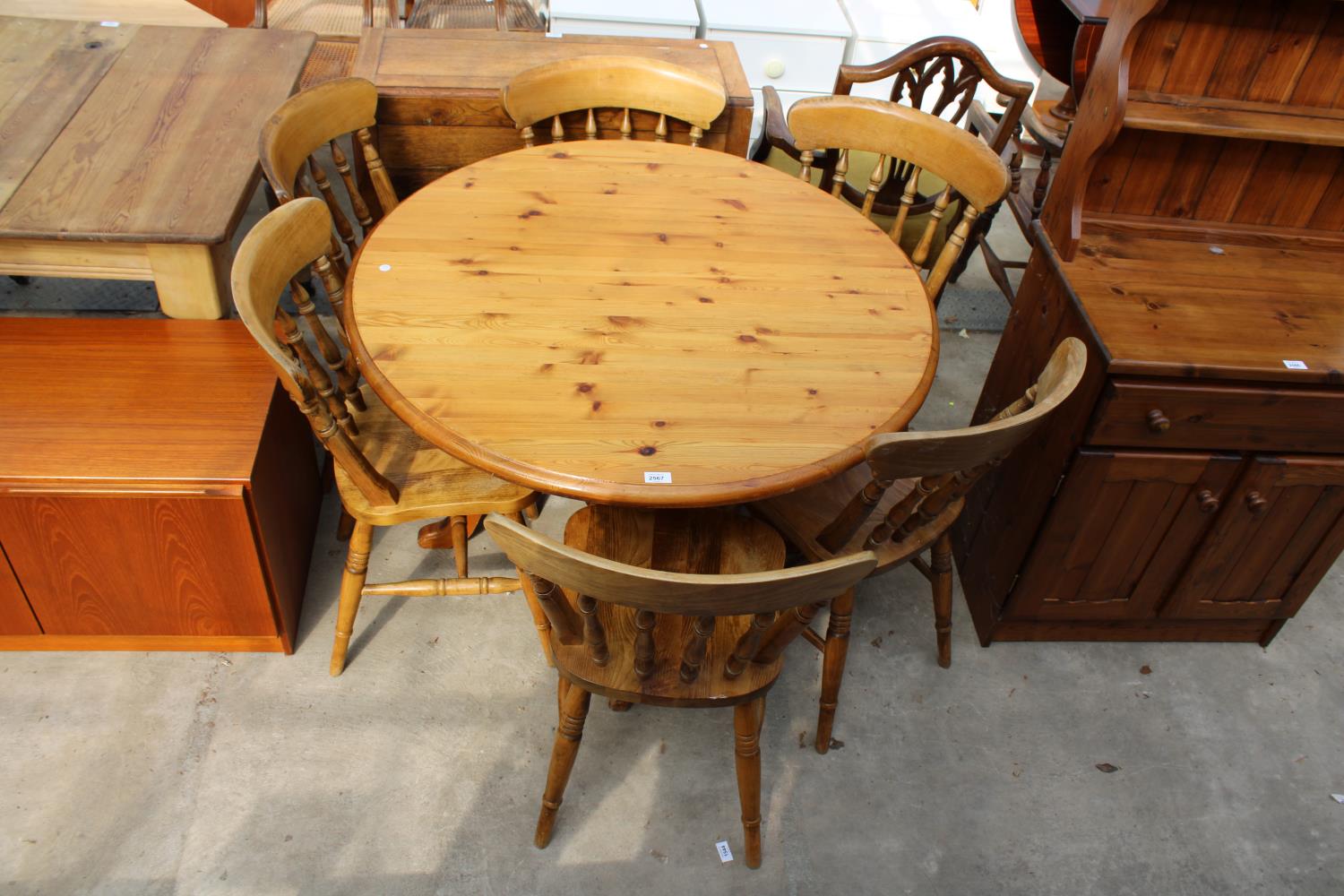 A PINE DINING TABLE ON PEDESTAL BASE (41" DIAMETER) AND SIX BEECH VICTORIAN STYLE CHAIRS