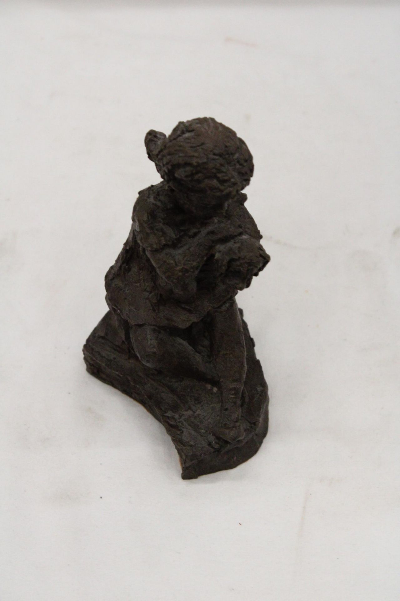 A VINTAGE RESIN SCULPTURE OF A GIRL WITH DOG - APPROXIMATELY 18CM HIGH