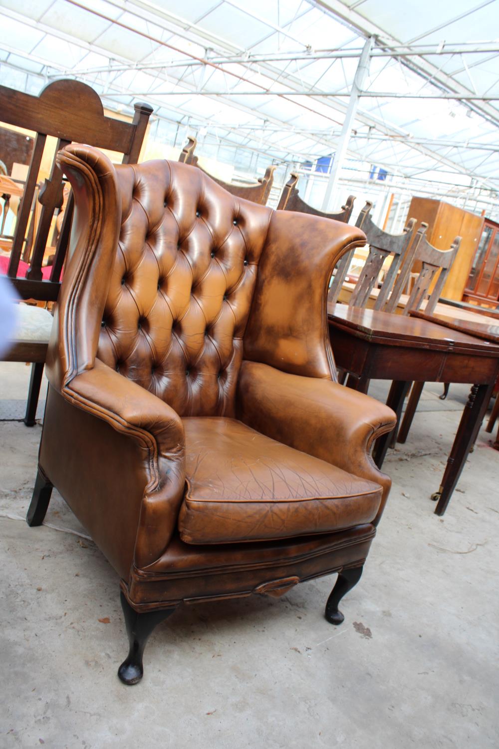 A BROWN CHESTERFIELD STYLE WINGED FIRESIDE CHAIR ON FRONT CABRIOLE LEGS - Image 2 of 2