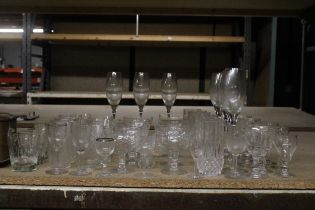 A LARGE QUANTITY OF GLASSES TO INCLUDE CHAMPAGNE FLUTES, WHISKY GLASSES, TUMBLERS, DESSERT