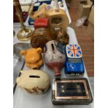 A COLLECTION OF NINE NOVELTY MONEY BOXES TO INCLUDE A MERRYTHOUGHT PIGGY, A ONE PENNY BOX, WINNIE-