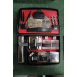 A VINTAGE GENTLEMANS GROOMING KIT CONTAINING BRUSHES, MANICURE ITEMS, BOTTLES, ETC IN A LEATHER CASE