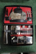 A VINTAGE GENTLEMANS GROOMING KIT CONTAINING BRUSHES, MANICURE ITEMS, BOTTLES, ETC IN A LEATHER CASE