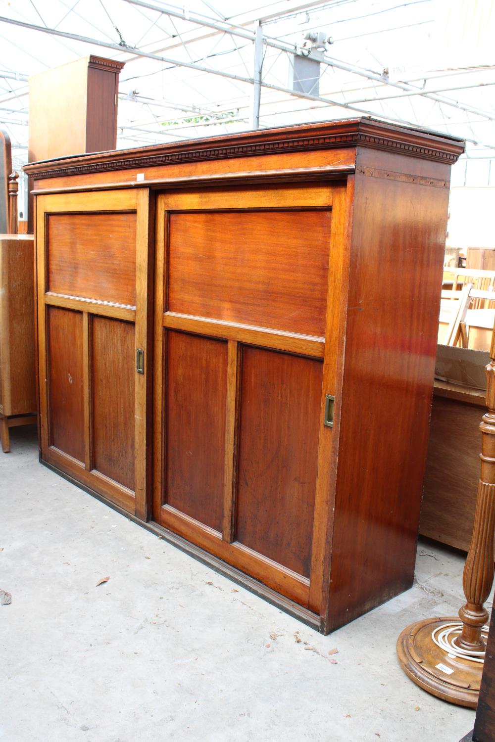 A VICTORIAN MAHOGANY STORAGE CABINET WITH TWO SLIDING DOORS HAVING SUNKEN BRASS HANDLES, 68" WIDE - Image 2 of 3