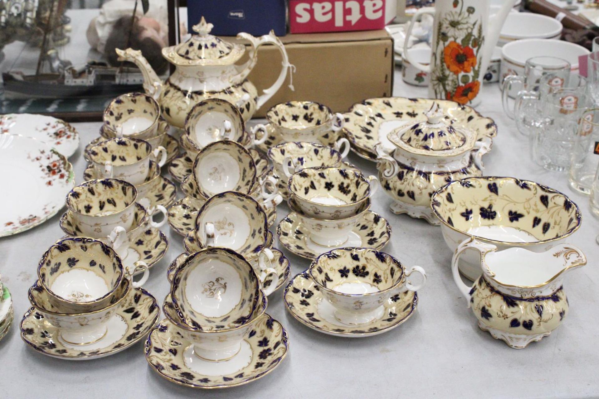 A MID CENTURY ROCKINGHAM PART TEA SET TO INCLUDE CUPS, SAUCERS, A TEAPOT, JUG, LARGE SUGAR BOWL PLUS