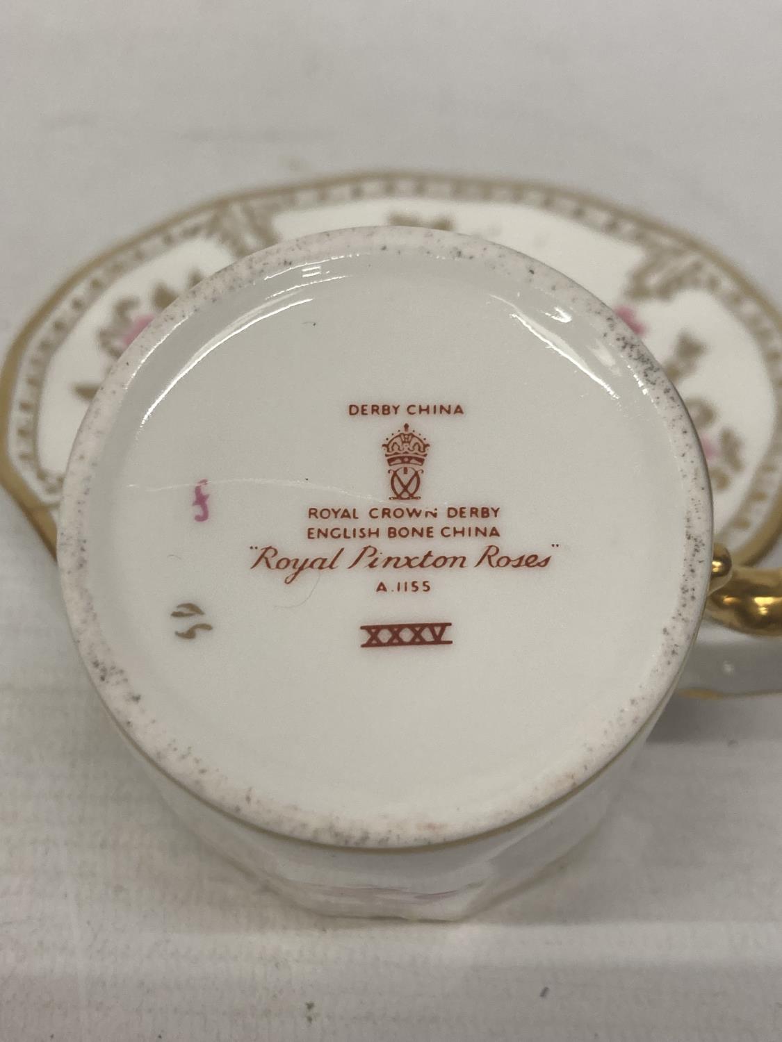 A ROYAL CROWN DERBY PINXTON ROSES COFFEE CAN AND SAUCER TOGETHER WITH A ROYAL CROWN DERBY TEACUP AND - Image 5 of 6