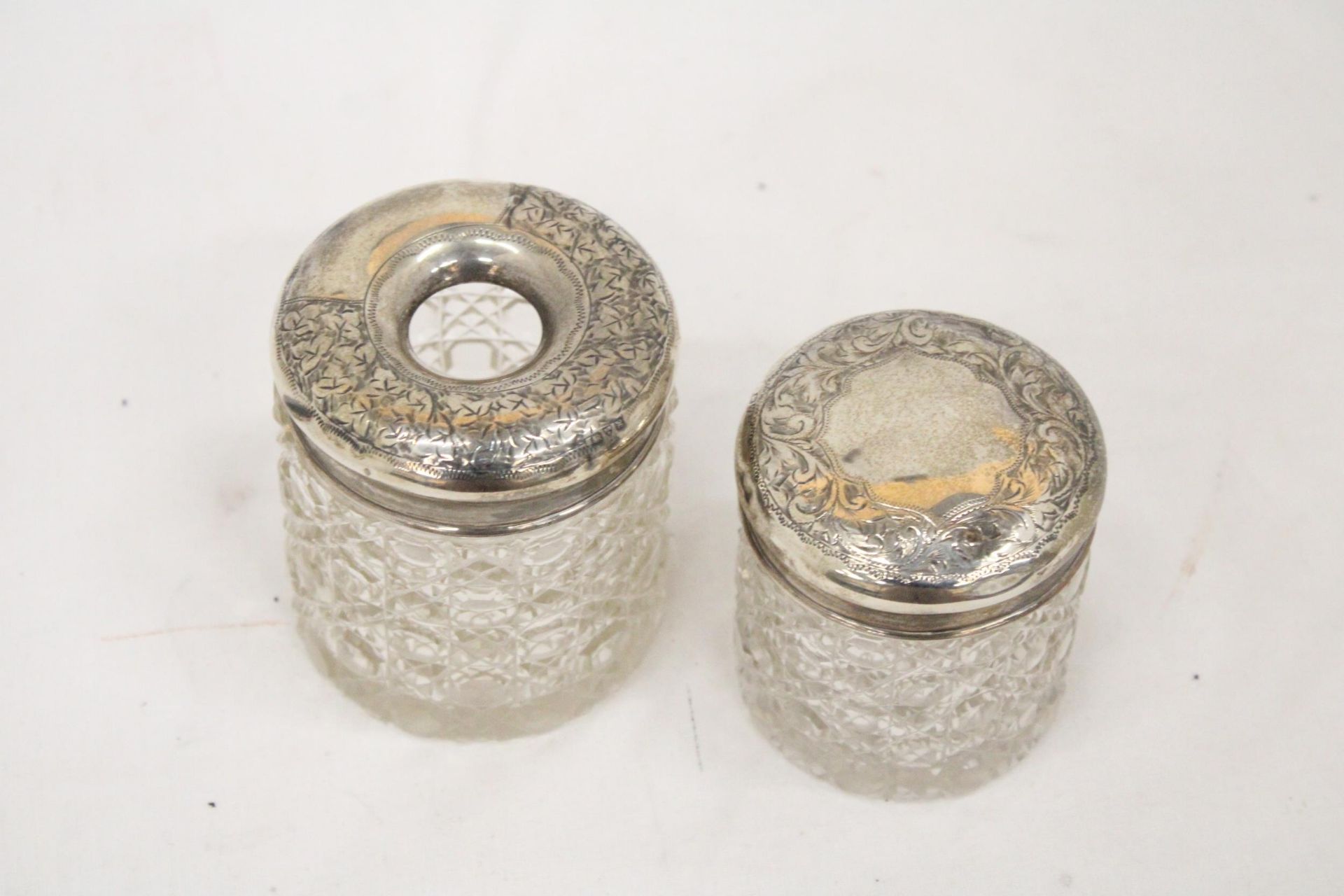 A STERLING SILVER TOP HAIR PIN JAR TOGETHER WITH A SILVER TOPPED COCKTAIL STICK HOLDER