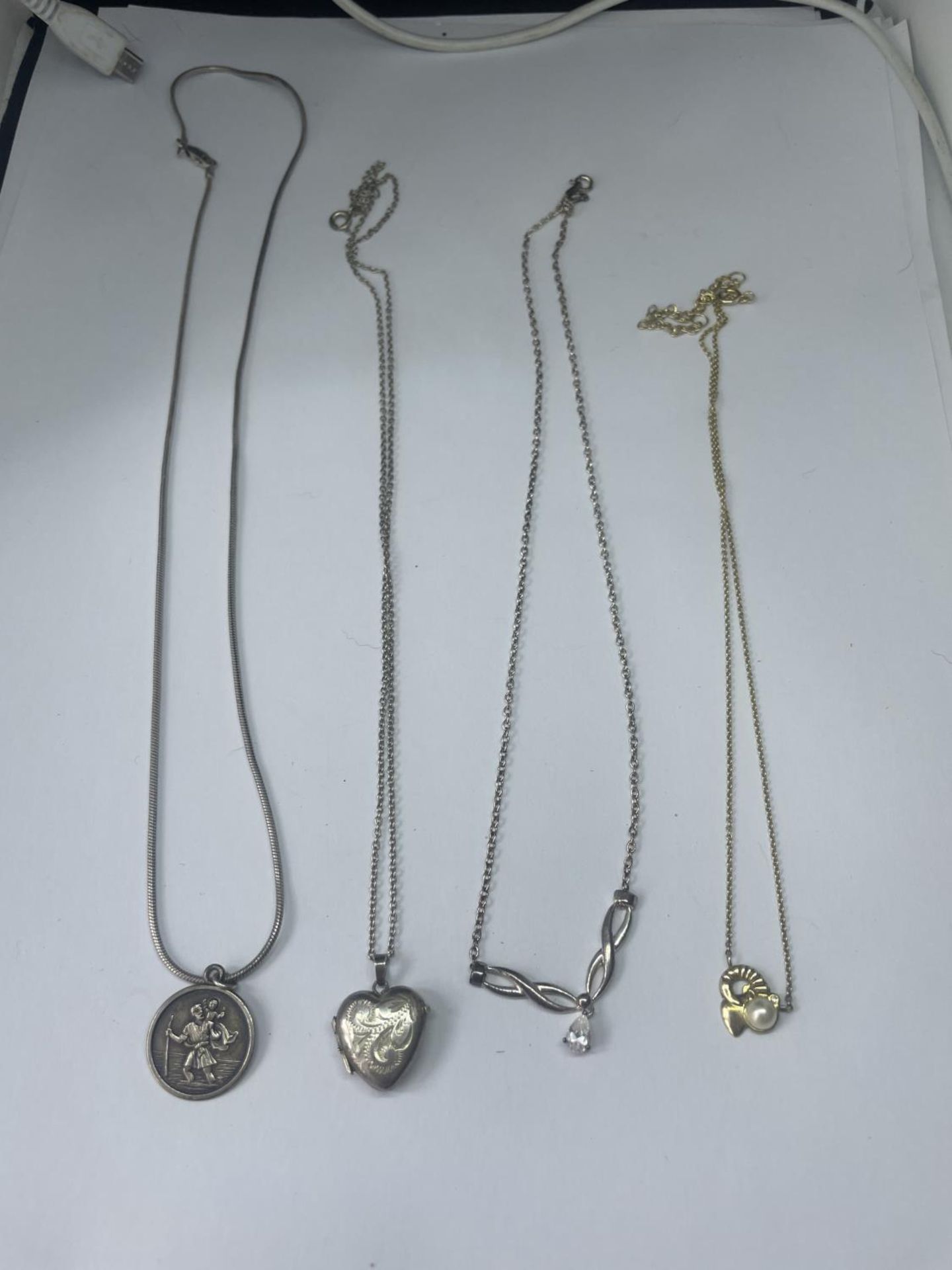 FOUR SILVER NECKLACES WITH PENDANTS