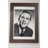 A SIGNED AND FRAMED NORMAN WISDOM PHOTOGRAPH