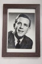 A SIGNED AND FRAMED NORMAN WISDOM PHOTOGRAPH