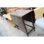 A MID 20TH CENTURY OAK DROP-LEAF TABLE WITH SWIVEL TOP ON BARLEY-TWIST LEGS