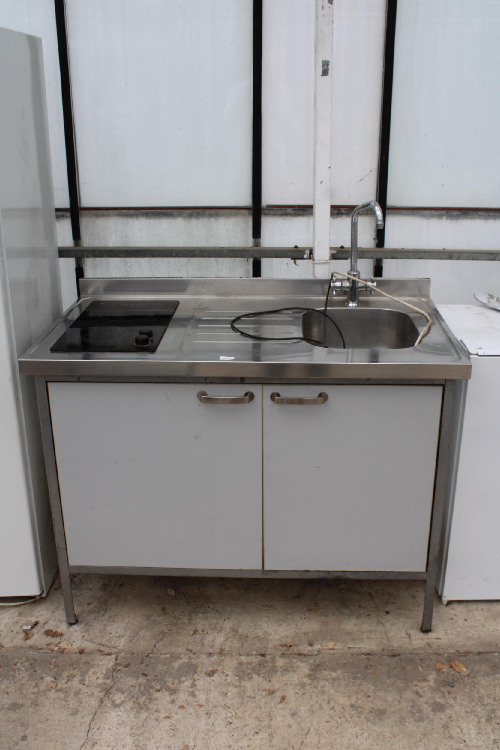 A STAINLESS STEEL SINK UNIT WITH BUILT IN UNDERCOUNTER FRIDGE AND COUNTER TOP HOB