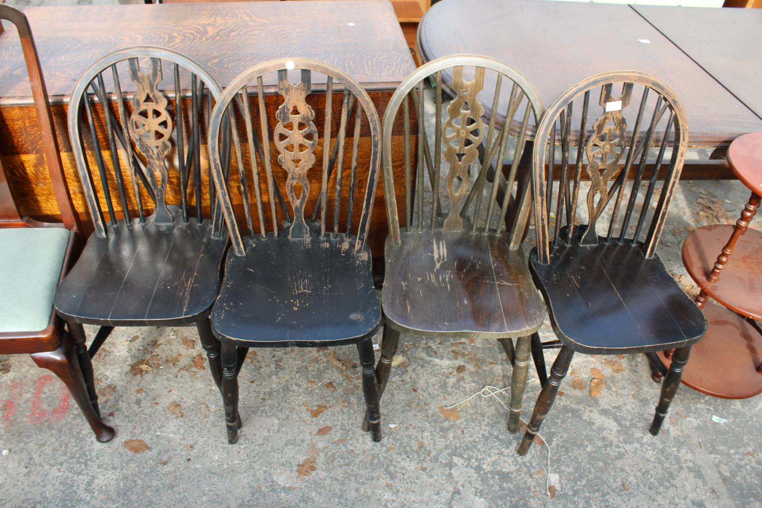 A SET OF FOUR WINDSOR STYLE WHEEL-BACK DINING CHAIRS