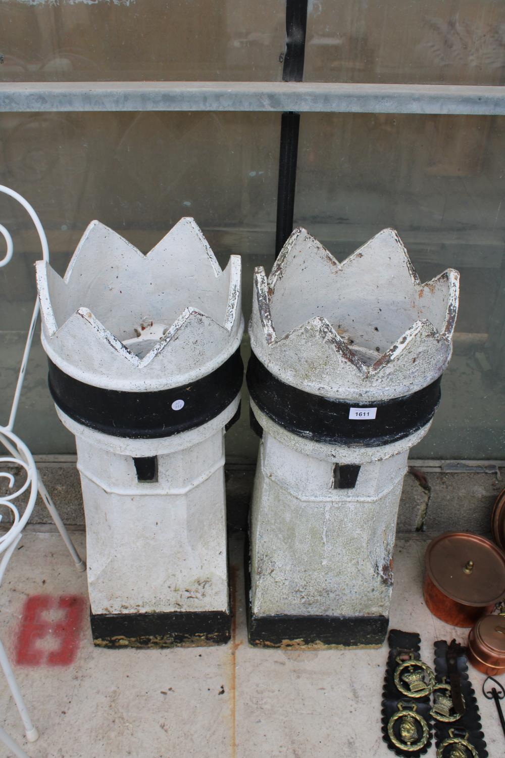 A PAIR OF BLACK AND WHITE PAINTED KINGS CHIMNEY POTS