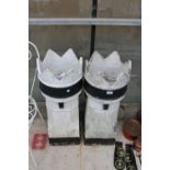 A PAIR OF BLACK AND WHITE PAINTED KINGS CHIMNEY POTS