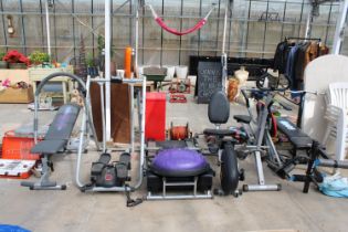 A LARGE QUANTITY OF HOME GYM EQUIPMENT TO INCLUDE A BENCH PRESS, ROWING MACHINE, AND CROSS TRAINER