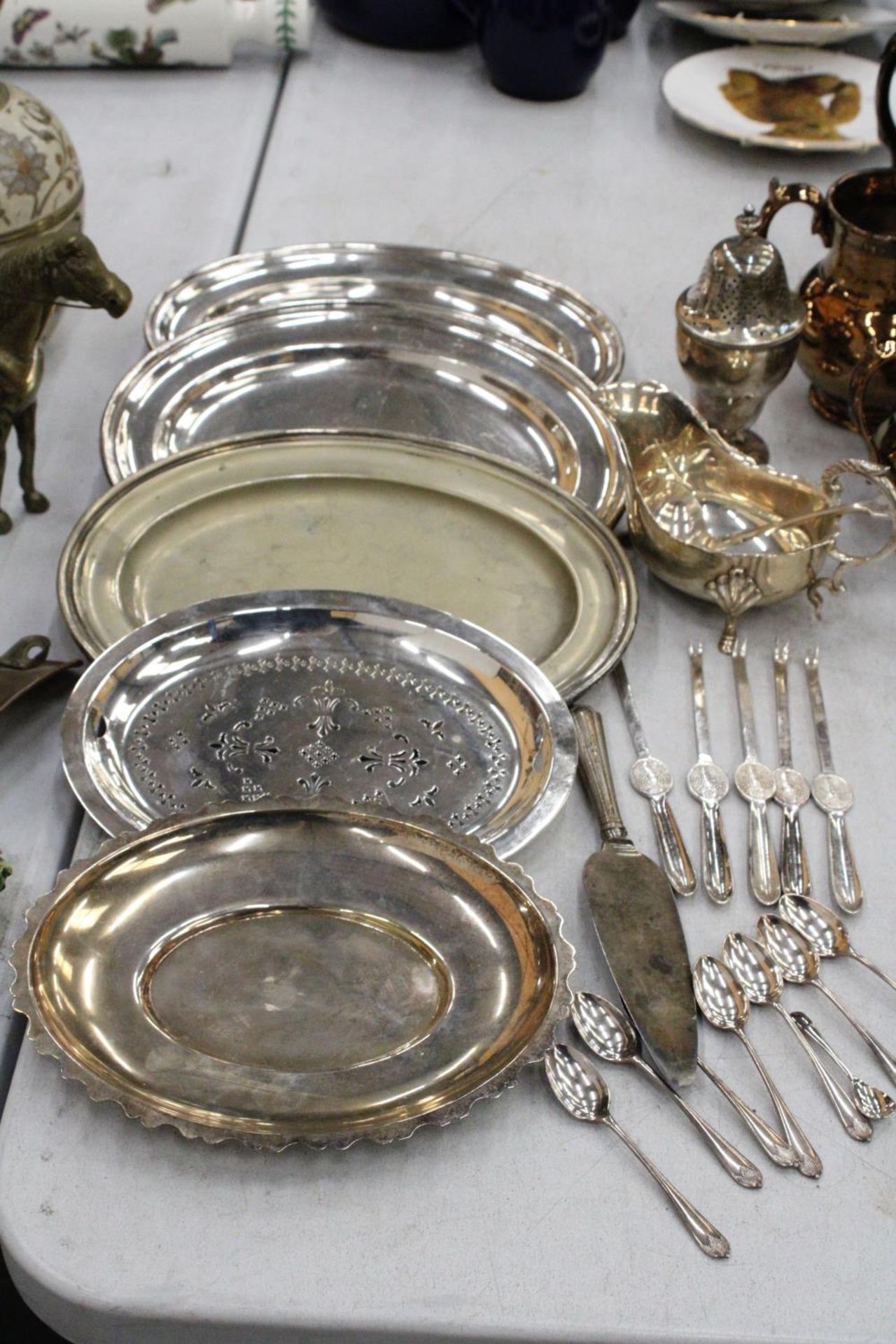 A MIXED LOT OF SILVER PLATE TO INCLUDE PLATES, SPOONS, GRAVY BOWL, SUGAR CASTER ETC