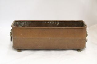 A VINTAGE COPPER PLANTER WITH LIONS HEAD HANDLES AND FEET