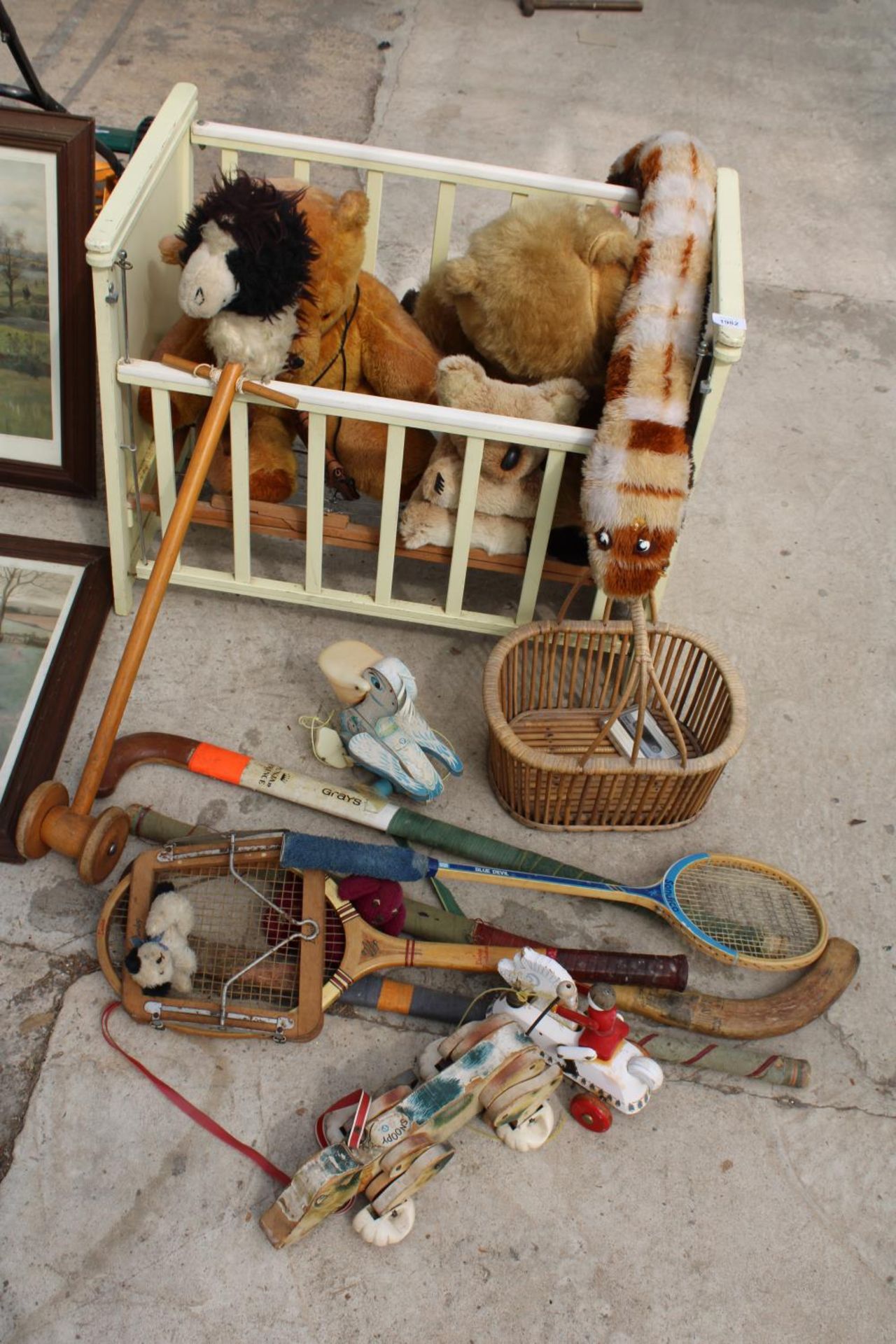 AN ASSORTMENT OF VINTAGE ITEMS TO INCLUDE HOCKEY STICKS, A COT AND TEDDIES ETC