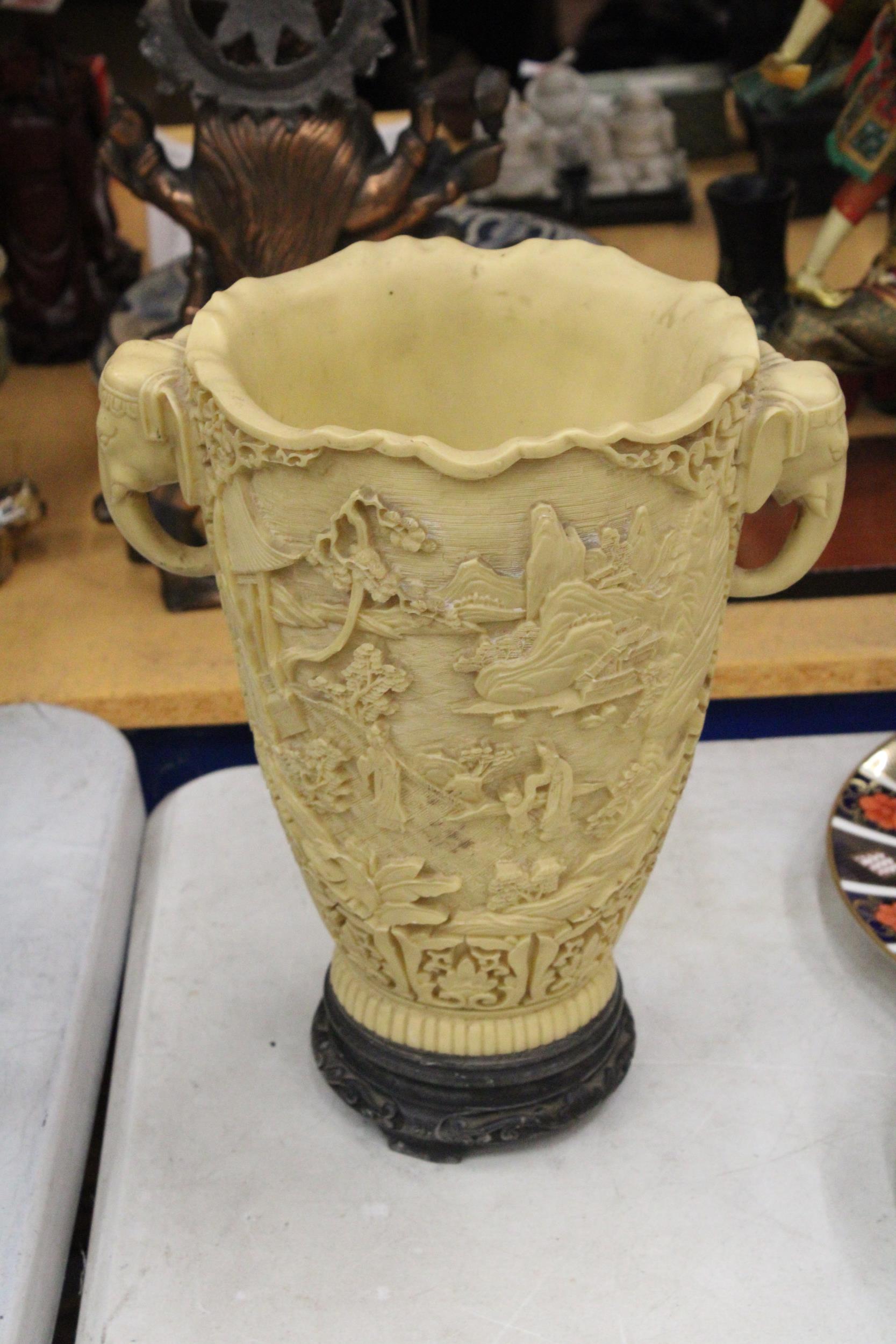 A LARGE CHINESE CARVED RESIN VASE WITH ELEPHANT HANDLES