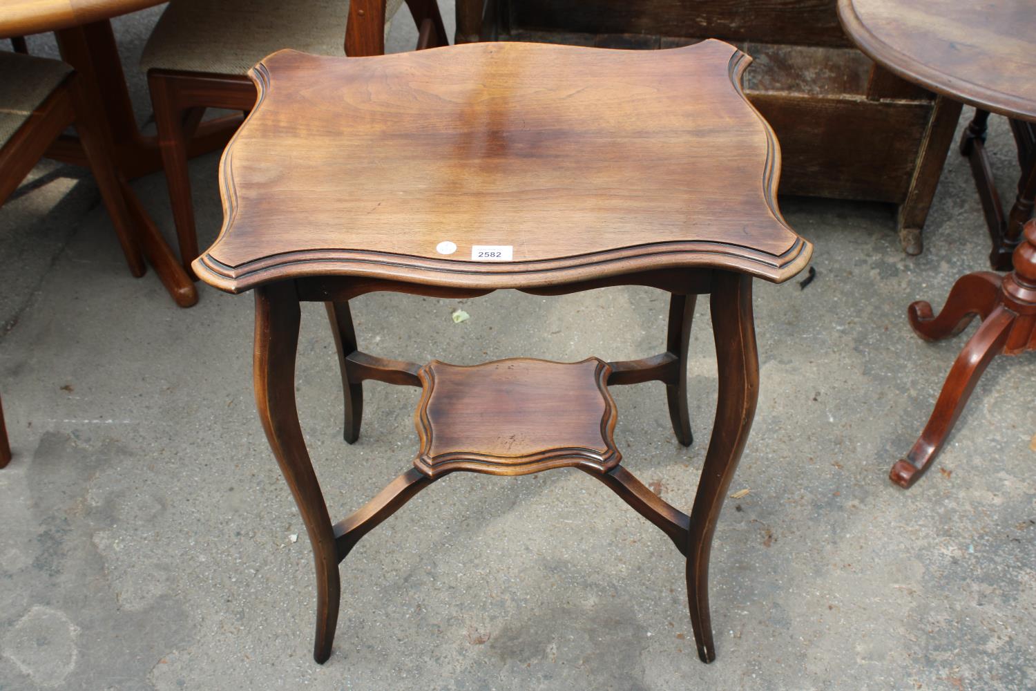 AN EDWARDIAN TWO TIER MAHOGANY OCCASIONAL TABLE, 24" X 18"