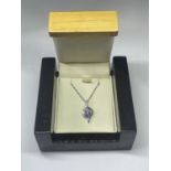 A SILVER NECKLACE WITH PURPLE STONE PENDANT IN A PRESENTATION BOX