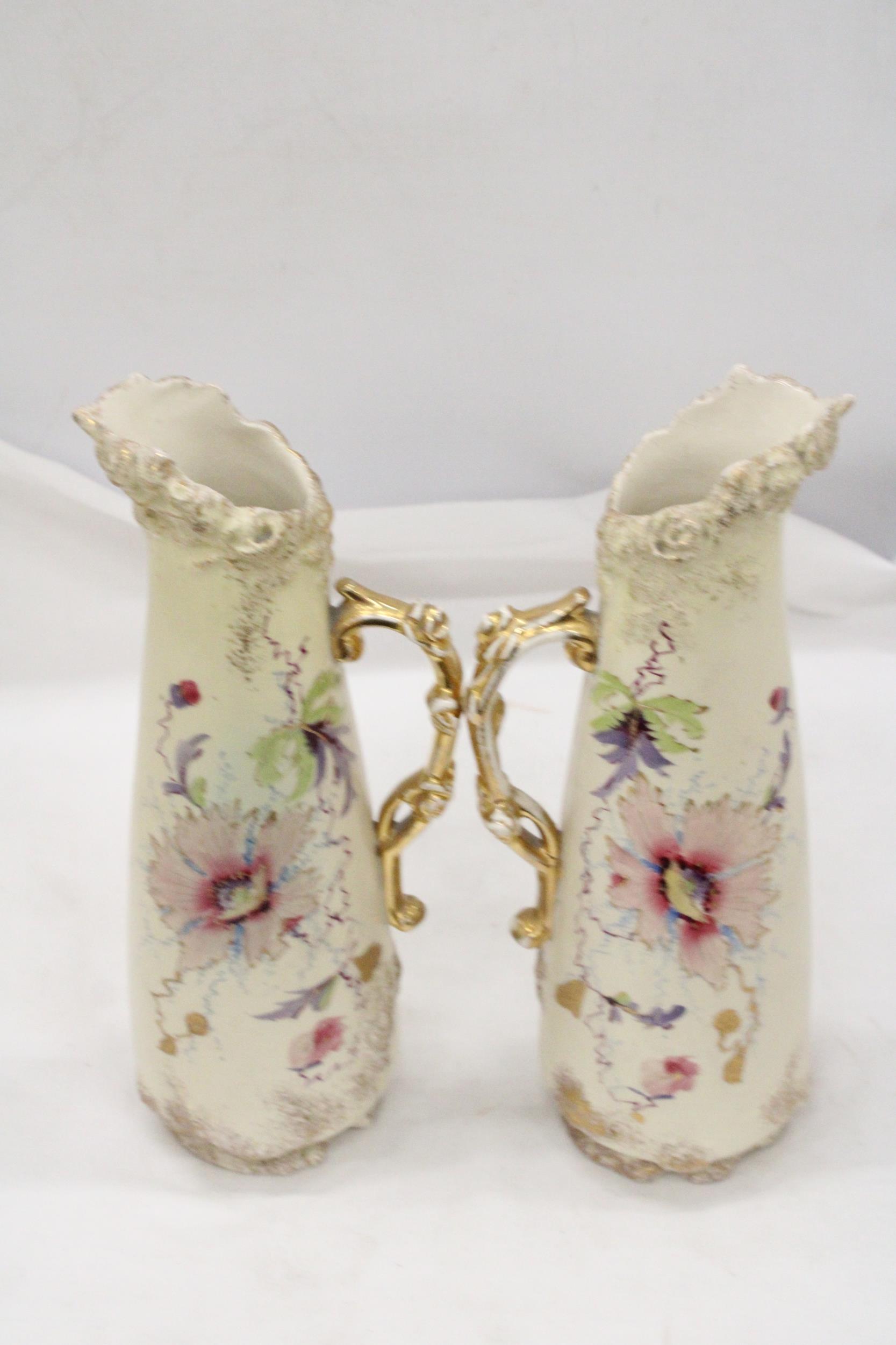 A PAIR OF VICTORIAN JUGS IN IVORY WITH FLORAL AND GILT DECORATION - APPROXIMATELY 31CM HIGH - Image 5 of 5