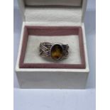 A MARKED SILVER DRESS RING WITH A SMOKEY AMBER COLOURED STONE SIZE O IN A PRESENTATION BOX