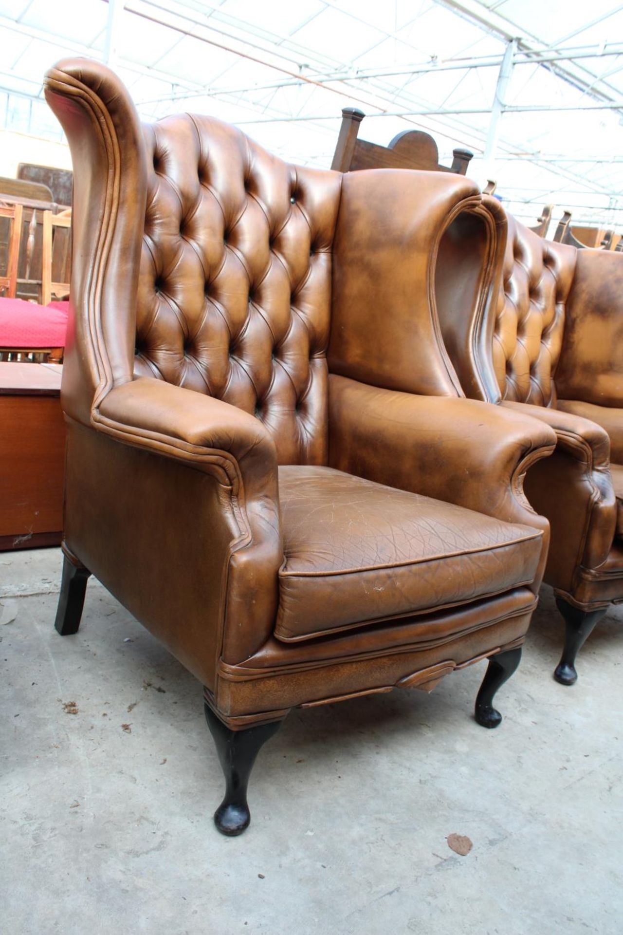 A BROWN CHESTERFIELD STYLE WINGED FIRESIDE CHAIR ON FRONT CABRIOLE LEGS - Image 2 of 2