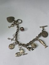 A CHARM BRACELET WITH TEN CHARMS