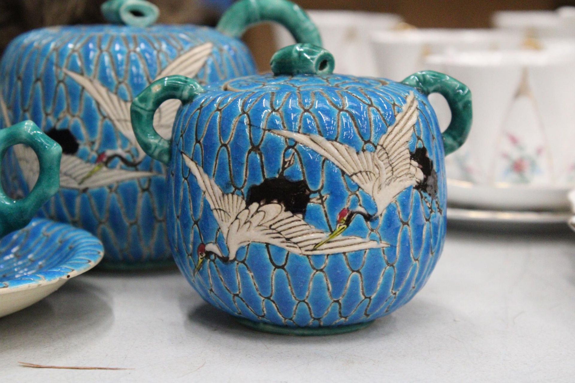 A JAPANESE SATSUMA BLUE MORRIAGE CRANE TEAPOT, LIDDED SUGAR BOWL AND TEACUP AND SAUCER - Image 2 of 7