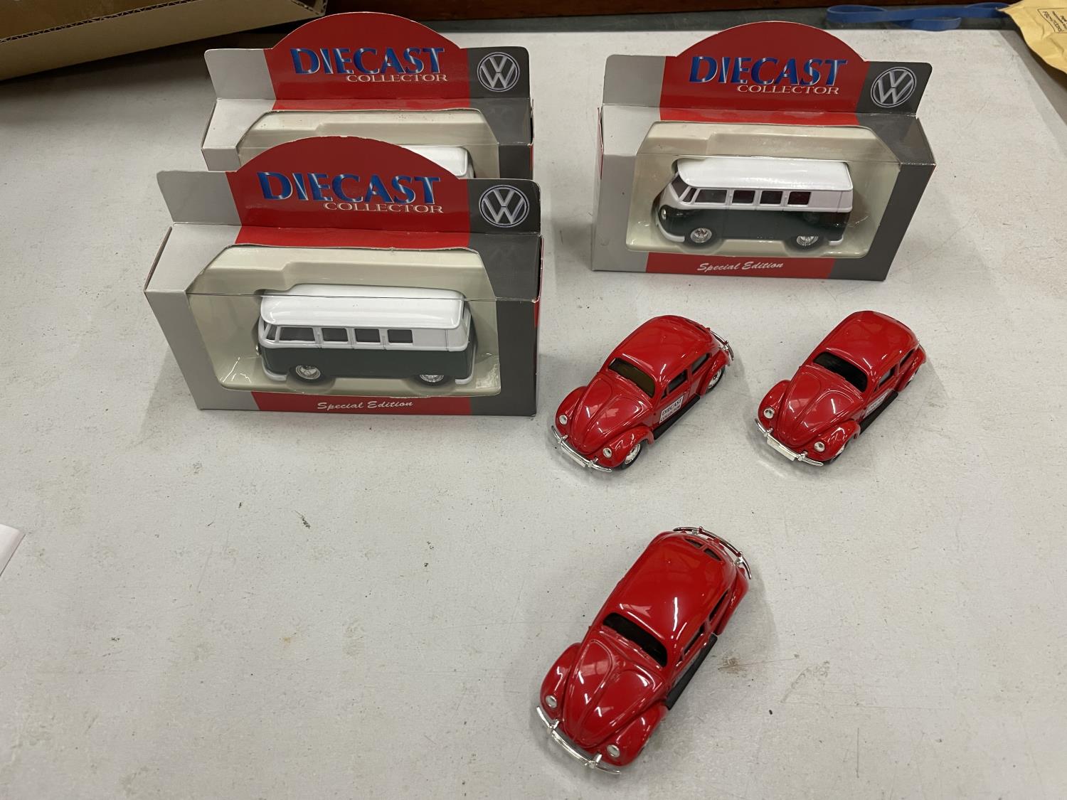 THREE BOXED DIECAST VW COLLECTOR CAMPER VANS WITH A FURTHER 3 UNBOXED VW BEETLES