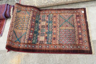 TWO VARIOUS RED PATTERNED RUGS