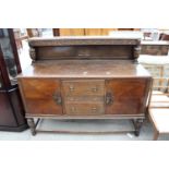 AN EARLY 20TH CENTURY OAK JACOBEAN STYLE SIDEBOARD, 60" WIDE, BEARING A. MARKS & SONS LTD (