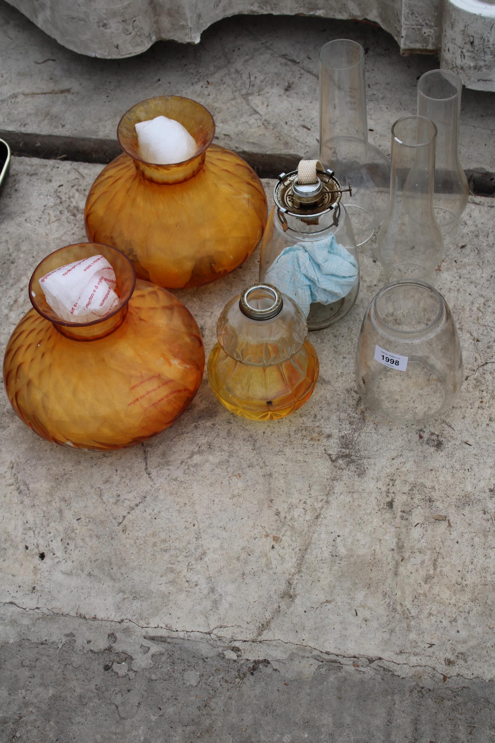 TWO GLASS OIL LAMPS WITH CLEAR AND ORANGE GLASS SHADES