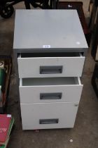 A THREE DRAWER METAL FILING CABINET