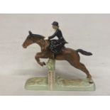 A BESWICK MODEL OF A HUNTSWOMAN JUMPING A FENCE