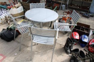A METAL BISTRO TABLE AND FOUR MATCHING CHAIRS