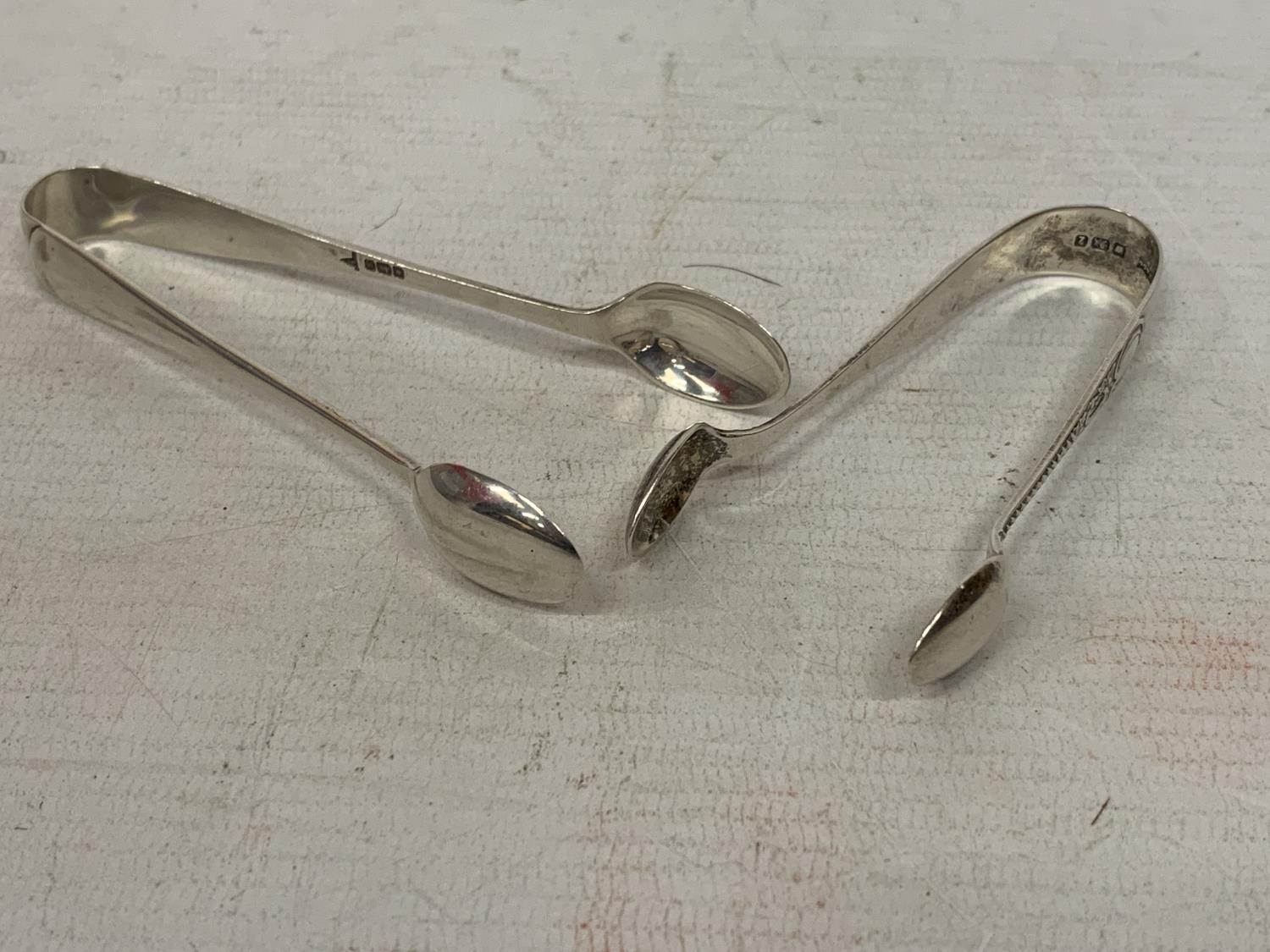 TWO PAIRS OF HALLMARKED SHEFFIELD SILVER SUGAR TONGS