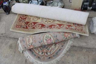 TWO CREAM PATTERNED RUGS TO INCLUDE AN OVAL FRINGED EXAMPLE