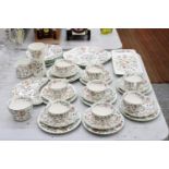 A LARGE MINTON "HADDON HALL" TEA SET TO INCLUDE CUPS, SAUCERS, SIDE PLATES, CAKE PLATES, SUGAR