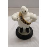 A VINTAGE ORIGINAL MICHELIN MAN ON TYRE APPROXIMATELY 33 CM HIGH