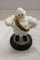 A VINTAGE ORIGINAL MICHELIN MAN ON TYRE APPROXIMATELY 33 CM HIGH