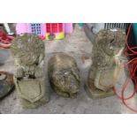 THREE RECONSTITUTED STONE GARDEN FIGURES TO INCLUDE A PAIR OF LIONS AND A PIG