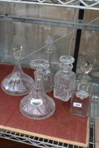 FIVE VARIOUS GLASS DECANTERS AND TWO COLLAR LABELS